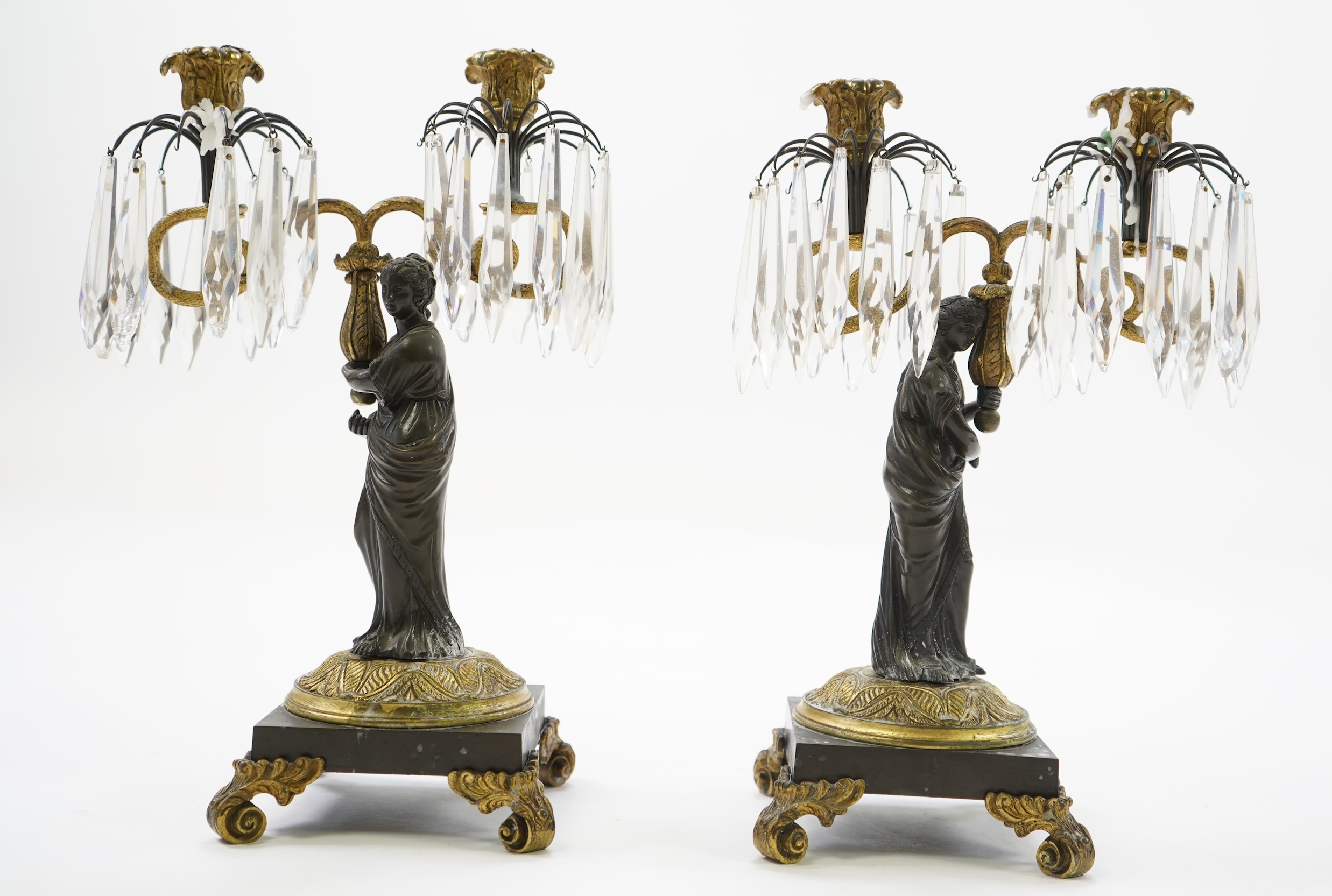 After Mathurin Moreau. A pair of mid 19th century bronze and gilt bronze two branch candelabra
